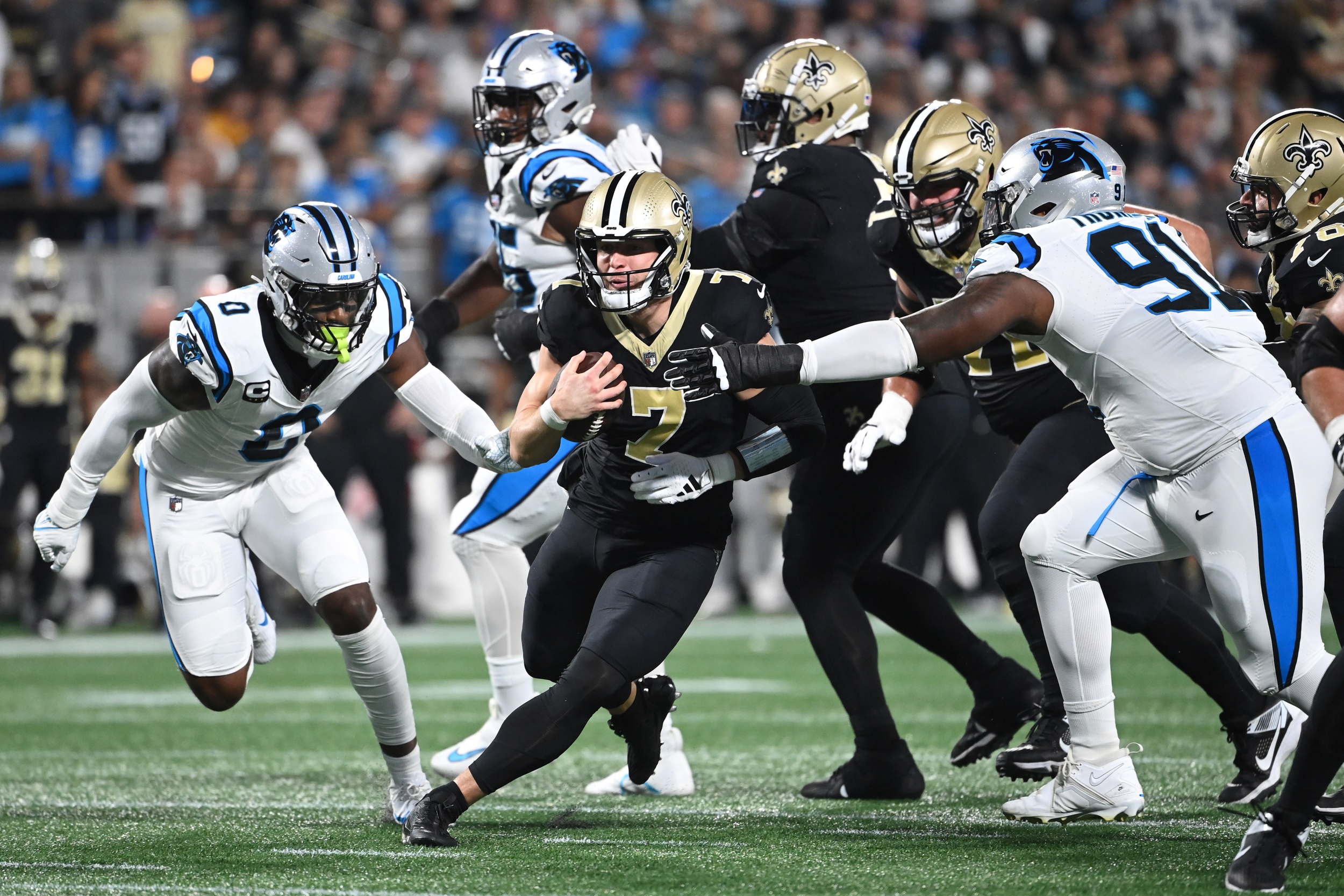 Sep 18, 2023; New Orleans Saints quarterback Taysom Hill (7) runs against Carolina Panthers linebacker Brian Burns (0) and defensive end Nick Thurman (91). Mandatory Credit: Bob Donnan-USA TODAY Sports